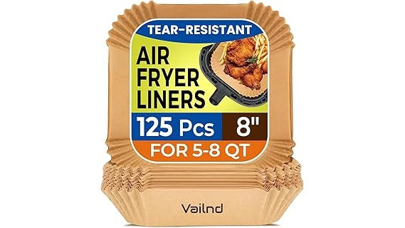 The image shows perfectly cooked food and parchment paper liners in an air fryer basket.